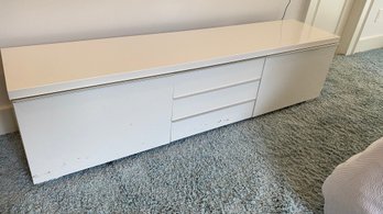 A White Low Profile Tv Stand With Drawers