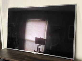 A 60 Inch Samsung Flat Screen TV With Stand And Remote