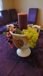 Decorative Urn With Grapes And A Candle