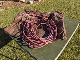 Grouping Of Two Includes A Brown Tarp And A Long Extension Cord