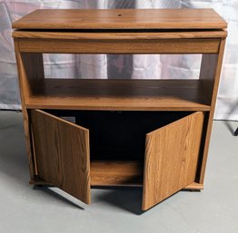 Swivel Top Television Stand In An Oak Finish, With A Shelf And Underneath Storage