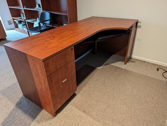 Section Of A Desk With A Keyboard Slide Out Shelf