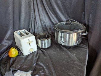 Grouping Of Three Kitchen Items Including Two Crock-pots And A Toaster
