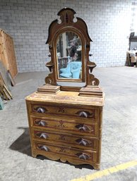 Antique Four Drawer Dresser With Mirror And Lidded Storage Boxes On Top.