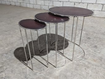 A Set Of Chrome Nesting Tables With Embossed Leather Tops