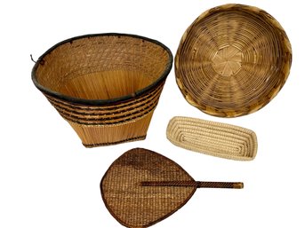 A Woven Collection Of Three Baskets And A Fan