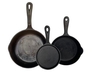 A Trio Of Vintage Cast Iron Skillets