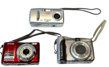 Trio Of Digital Cameras -NIKON, Canon, Olympus