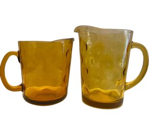 A Pair Of Vintage Amber Glass Pitchers