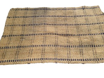 A Natural Jute Rug  By The  'company Store' With A Navy Flat Weeve Stripe