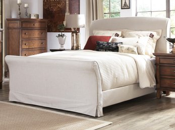 A Queen Size Sleigh Bed In Upholstered Linen By Pottern Barn