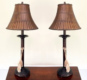 A Pair Of Stick Lamps With Bamboo Shades