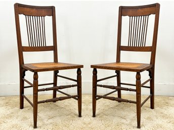 A Pair Of Edwardian Oak Cane Seated Side Chairs