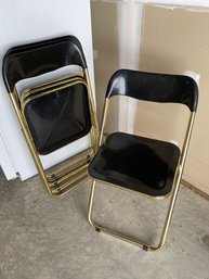 Four Folding Black Acrylic And Golf Finish Chairs