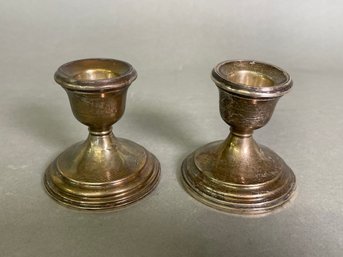 A Pair Of Weighted Sterling Silver Candlesticks