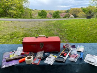 A Red Vintage Tool Box With Many Extras