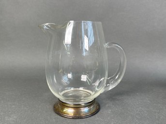 A Glass Pitcher With Sterling Silver Base