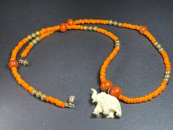 1989s Orange Glass Beaded Necklace W Carved Bone Elephant