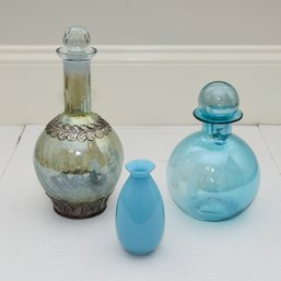1 Crackle Glass Decanter With Silver Metal Detailing, 1 Blue Glass Decanter And 1 Aqua Blue Ceramic Bud Vase