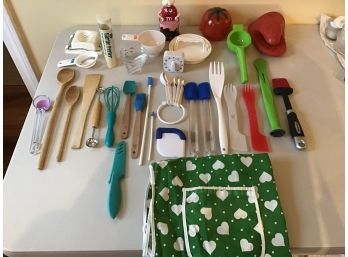 A Fun Variety Of Cooking Utensils And Green/ White Heart Apron