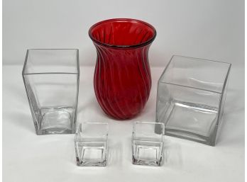 Three Glass Vases Together With A Pair Of Votive Candle Holders