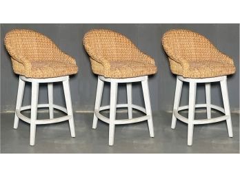 A Trio Of Swivel Bar Stools In Coastal Woven Fiber By Pottery Barn