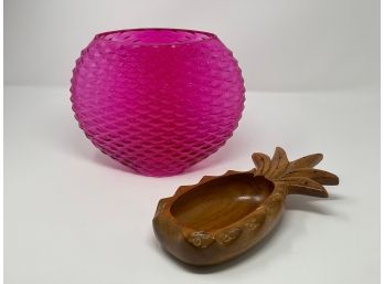 A Fuchsia Colored Oval Glass Vase Together With A Carved Wooden Pineapple Bowl