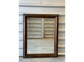 Beveled Mirror With Ornately Carved Wooden Frame