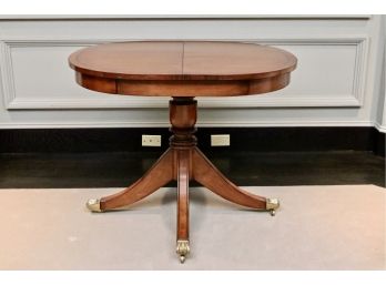 Oval Pedestal Table With Brass Claw Castered Feet