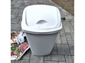 GARBAGE CAN AND BUNDLES OF FABRIC