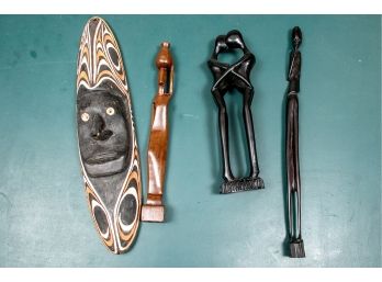 A Group Of Carved Items From New Guinea