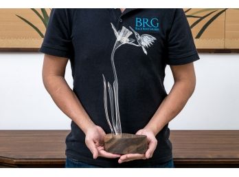 Glass Hummingbird And Flower Resting On Wooden Base