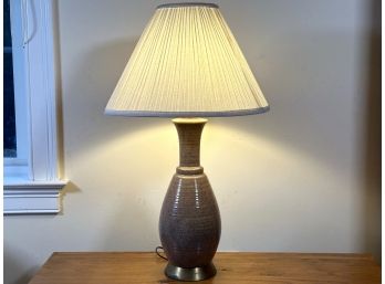 A Mid-Century Style Pottery Lamp With A Pleated Shade