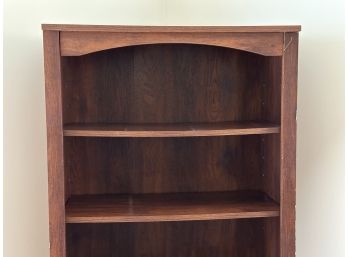 A Tall Laminated Bookcase With Adjustable Shelves