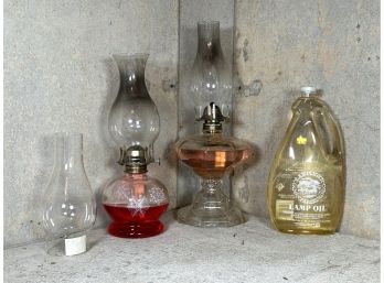 A Pair Of Vintage Oil Lamps, Spare Chimney & Oil Supply