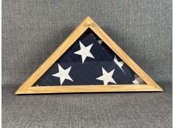 A Classic Glass Display Case With A Folded American Flag