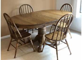 Oak Pedestal Table With Two Leaves And Four Chairs