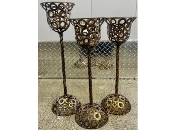 Three Tall Gilt Metal Candlesticks