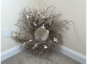 A Pretty Branch Wreath With White Faux Flowers