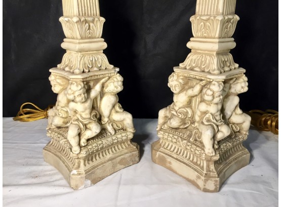 Pair Of Molded Column Form Table Lamps With Cherubs Holding Up The Base