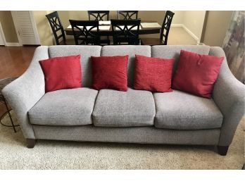 Stylish Gray Tone Couch With A Nice Red Accent Pillows