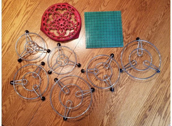 Selection Of Mostly Metal And A Ceramic Trivets
