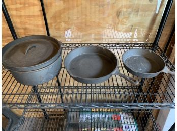 Three Cast Iron Pans, One With Lid