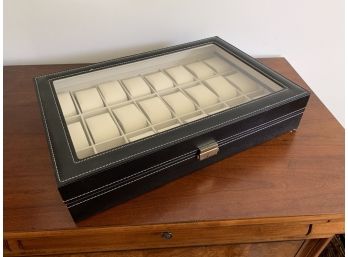 A Black Leather Watch Storage Case With Glass Top