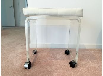 A Lucite Vanity Seat On Casters