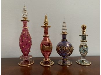 Set Of Four Gilt Decorated Glass Perfume Bottles