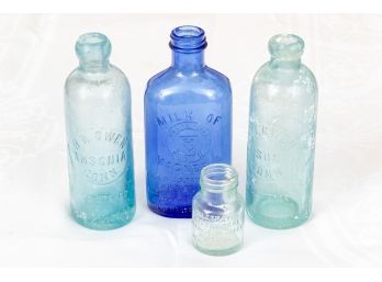 (4) A Collection Of Antique Medicine Bottles