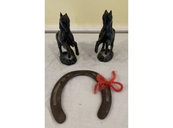 Two Cast Iron Horsed And Horse Shoe