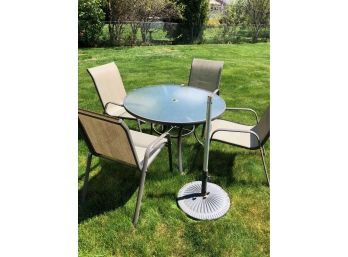 Outdoor Round Table Set With 4 Chairs And A Umbrella Stand