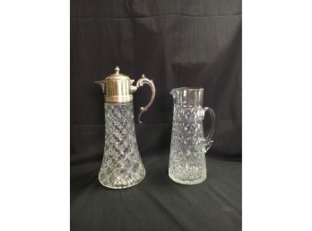 B40 Lot Of 2 Glass Pitchers, One With Silverplate Top, 11” And 13”